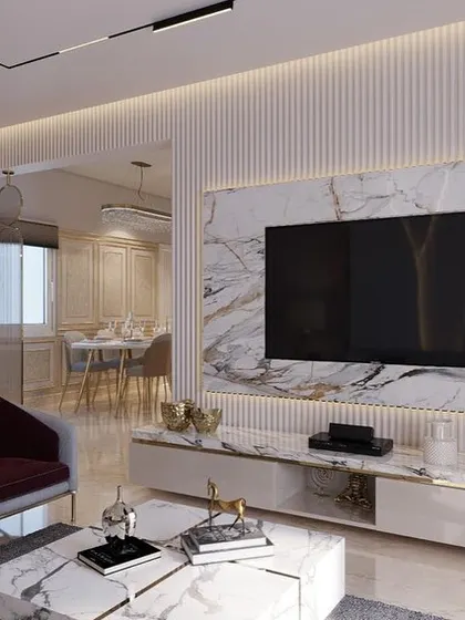 A luxurious render of the living room, envisioning a space defined by white marble, fluted walls, and deep burgundy accent chairs.