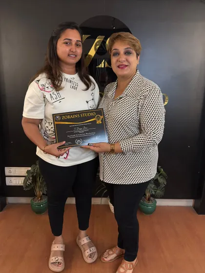 A student receives her certificate after successfully completing our hands-on Elleza Lash Extension workshop.