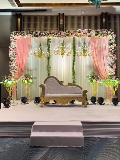 A closer look at the pastel-themed stage. The combination of the vintage lounge, soft pink curtains, and delicate floral arrangements creates a romantic and sophisticated atmosphere.
