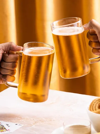 A lifestyle shot of two people cheering with beer mugs. This creates an emotional connection by associating the product with friendship and celebration.