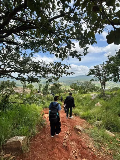 Descending the earthy-red trails of Makalidurga, framed by lush greenery. We guide teams through diverse terrains, ensuring a safe and engaging hiking experience for all fitness levels.
