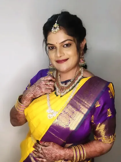 A happy and confident portrait of Pratima, showcasing the complete traditional look for a family wedding.