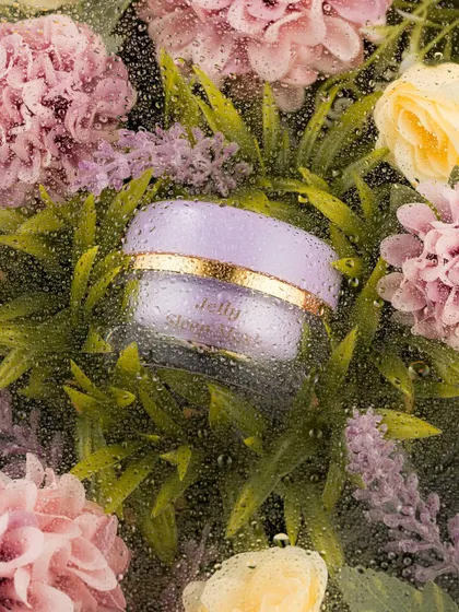 A creative and evocative shot of a product jar nestled among flowers, viewed through a water-beaded glass. This technique adds texture and a sense of freshness, as if the product is a natural treasure discovered in a misty garden.