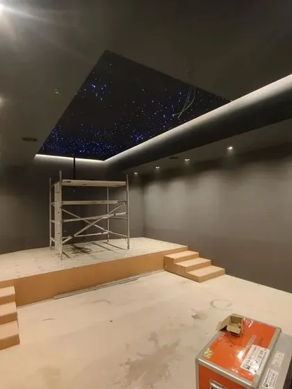 The room is taking shape. The seating platform is complete, and the walls are ready for the final layer of acoustic paneling and fabric.