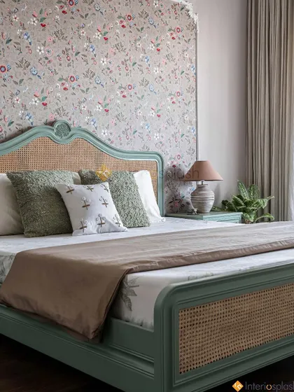 This bedroom has a vintage charm, with a custom-painted bed frame and a beautiful floral wallpaper accent wall. The design is cozy, personal, and full of character.