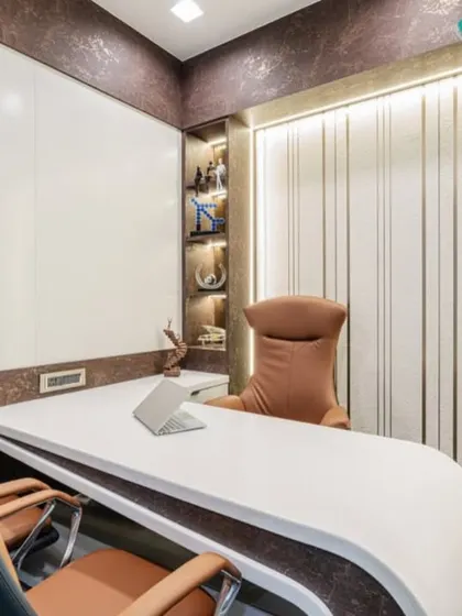 This executive cabin features a modern curved desk, a large whiteboard wall for strategy sessions, and elegant built-in shelving with accent lighting. The design is a perfect blend of high-end aesthetics and practical functionality.