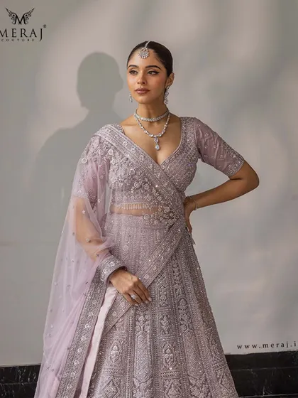 Soft, sophisticated, and sparkling. This lilac lehenga from the 'Ruvaah' collection is adorned with intricate sequin detailing, delicate threadwork, and elegant pearl accents.