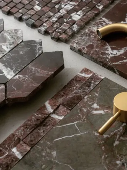 A mood board showcasing a combination of elegance. Red Lavante marble, with its rich tones, is paired with brushed gold fixtures to create a look that is both classic and luxurious.