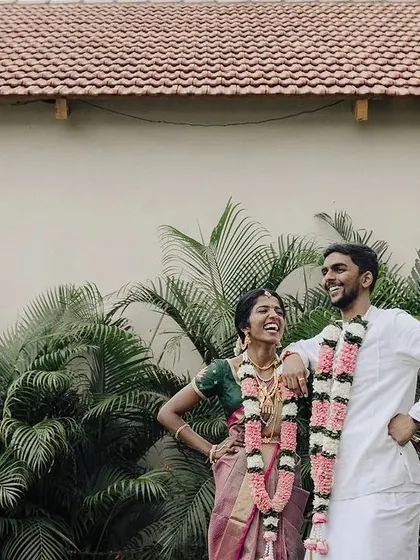 A relaxed and fun portrait of a couple sharing a laugh. Their casual poses and genuine smiles create a photo that feels authentic and full of personality.