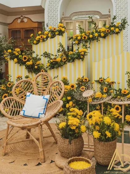 The main seating for the bride-to-be at her Haldi, a beautiful wicker peacock chair surrounded by a sea of sunflowers.
