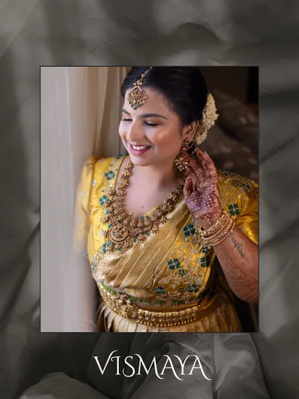 A beautifully edited portrait of the bride, framed to highlight her joyful expression and the intricate details of her traditional gold jewelry.