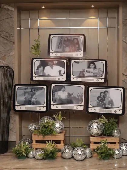 A closer look at the vintage TV photo wall, surrounded by disco balls to complete the retro vibe.