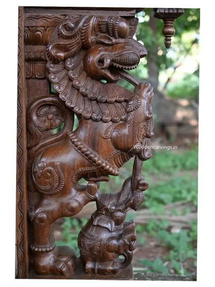 A close-up of the Yaali's head and the elephant it holds in its trunk, showcasing the fierce expression and detailed carving.