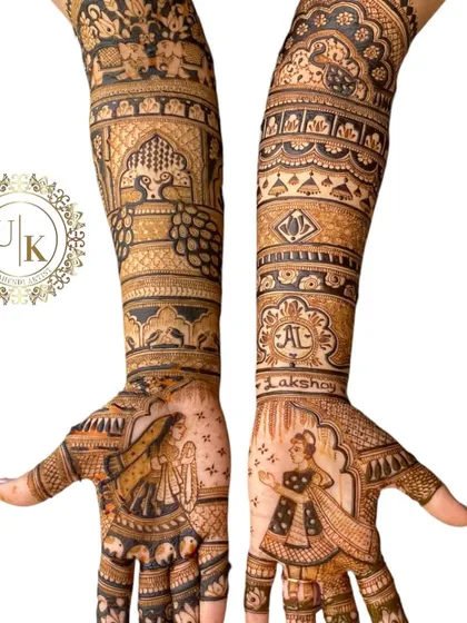 A stunning example of portrait mehandi. The bride's palms feature detailed figures of a groom and a dancing bride, surrounded by intricate traditional patterns.