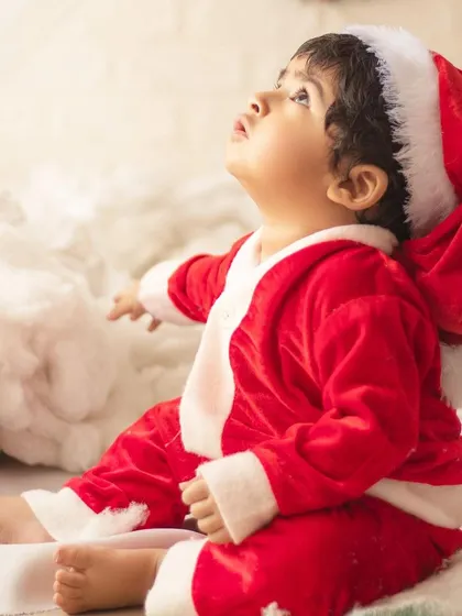 This little one is looking up at the Christmas magic. I use lighting to create a warm, wondrous glow in my holiday photos.