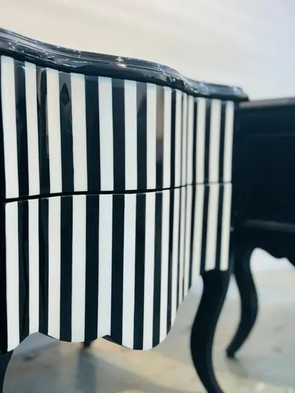 A close-up detail of the glossy, striped finish on our custom side cabinets, showing the precision of the pattern and the quality of the lacquer work.