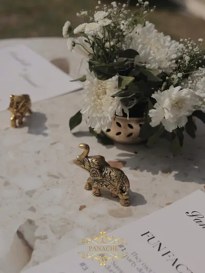 The little details matter. Tiny golden elephant figurines were used as paperweights for the fun-fact cards placed on each table.