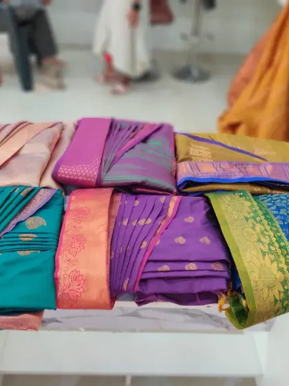 Glimpses of a saree draping class, with a beautiful array of colorful sarees perfectly folded and pleated by my talented students.