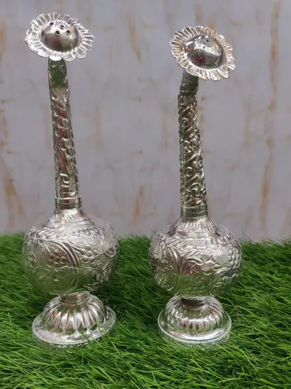 A pair of beautifully designed German silver paneer daanis. The long neck allows for a gentle sprinkle of gulab jal.
