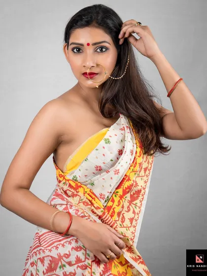 A close-up portrait emphasizing the model's direct and engaging gaze. Dressed in a traditional saree and nose ring, this shot is all about capturing raw expression and connection.