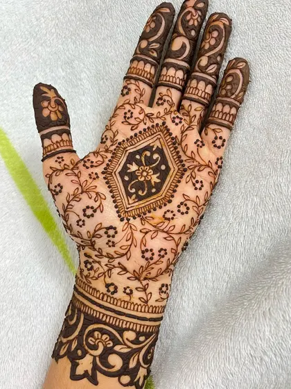 Another shot of the full party henna design, highlighting the contrast between the dark cuff and the delicate vines.