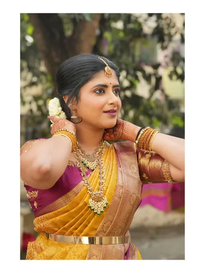 Dressed in a beautiful yellow and pink silk saree. I love the richness of traditional Indian textiles and jewelry.
