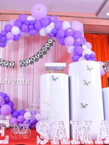 A simple yet elegant purple butterfly theme with a circular arch and marquee letters.