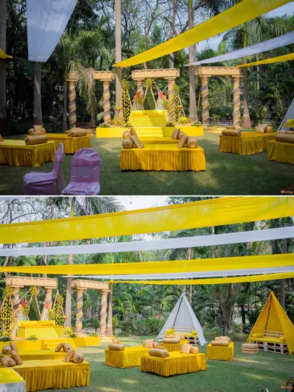 A view of the beautiful yellow-themed Haldi decor, featuring a swing for the couple and cozy tent seating for guests.