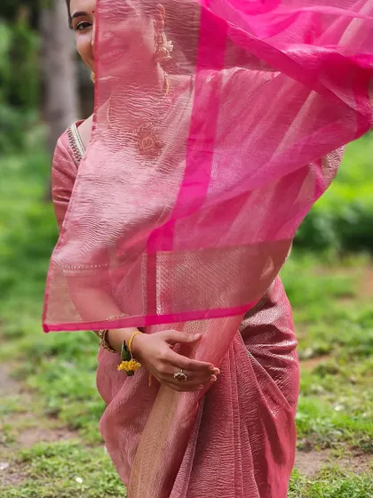 A playful shot showing the sheer pallu of the pink linen saree. It's all about feeling comfortable and beautiful in what you wear.