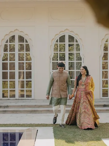 A romantic walk by the pool at a luxury hotel. This shot captures the couple in a serene, elegant environment during their wedding festivities.
