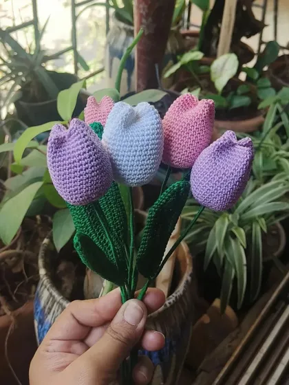 A lovely bunch of our handmade crochet tulips in shades of lavender, white, and pink. Each petal and leaf is carefully stitched to create a realistic and charming floral piece.