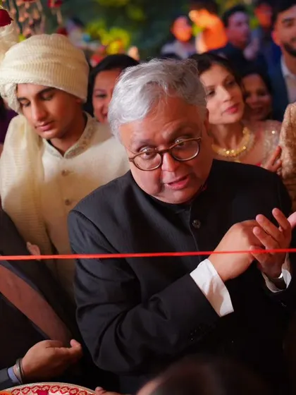 The playful ribbon-cutting ceremony, a fun tradition where the bride's family playfully stops the groom from entering.