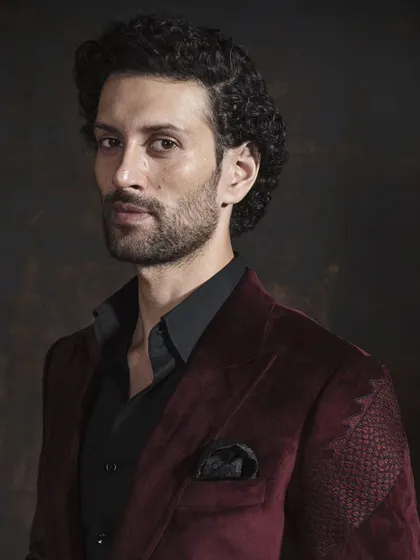 A portrait in the maroon velvet blazer. The rich color and texture speak of sophistication, showcasing the art of bespoke fashion.