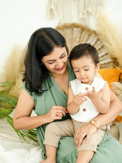 A quiet moment of discovery between mother and son. I love capturing these little interactions, like examining tiny fingers, that speak volumes about their bond.