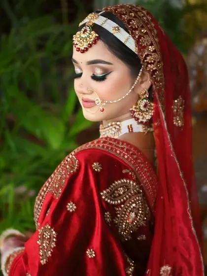 A side profile showcasing the beautiful hair accessory and the soft, glowing makeup.