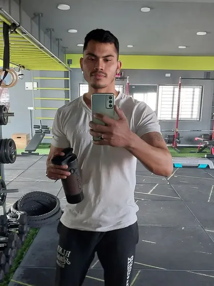 A quick progress check in the gym mirror. I help clients track their muscle development and celebrate their achievements.