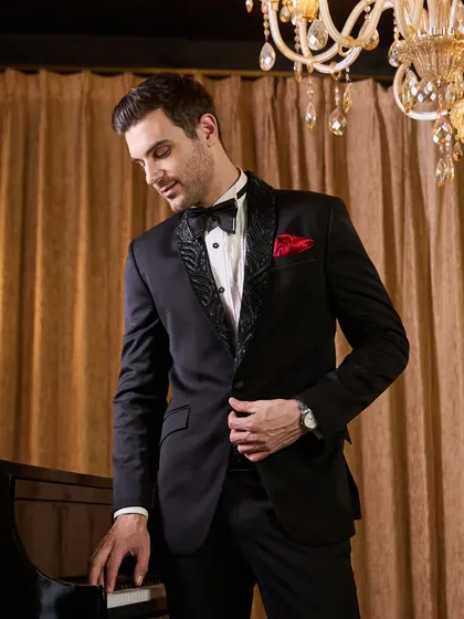 A closer look at the details of my black tuxedo. The lapel features a subtle, elegant pattern that catches the light, adding a layer of texture and sophistication to the classic silhouette. It's these small touches that define true bespoke tailoring.