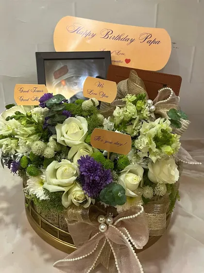 A slightly different angle of the birthday hamper for 'Papa', showing the depth of the floral arrangement and the careful placement of each personalized element.