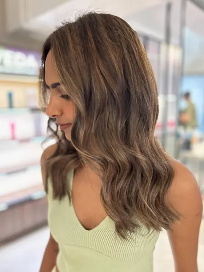 A beautiful three-tone hair color with beige highlights. The face-framing layers add shape and movement to this fresh new look.