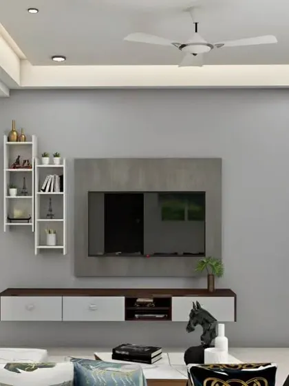 A simple and clean TV unit design with a concrete-finish back panel. The floating console and asymmetrical shelving add a touch of modern flair.