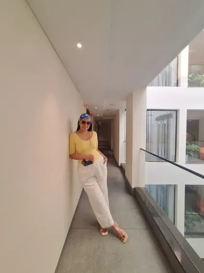 Mentally, I'm still in Goa. This casual look with white linen pants, a yellow top, and a printed bandana is the essence of relaxed vacation style.