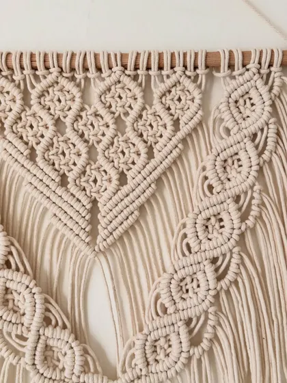 The beautiful braided details that frame the central pattern of this handmade wall hanging.