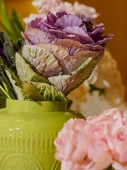 A close-up of a unique floral element, featuring a purple ornamental cabbage. This shows my commitment to using interesting and unconventional flowers to create unique arrangements.
