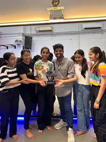 The whole team celebrating their win at the Bombay Scottish School competition. A testament to their talent and teamwork.