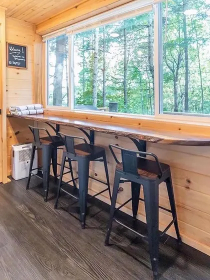 A window-side counter with bar stools is a great space-saving solution for dining. It also provides a lovely spot to enjoy a meal with a view.