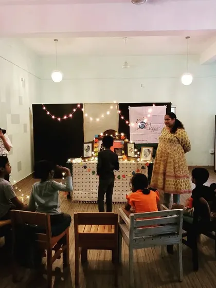 A full view of our workshop setup, with kids seated and ready for the story to begin. The fairy lights and backdrop create a special stage for our performance.
