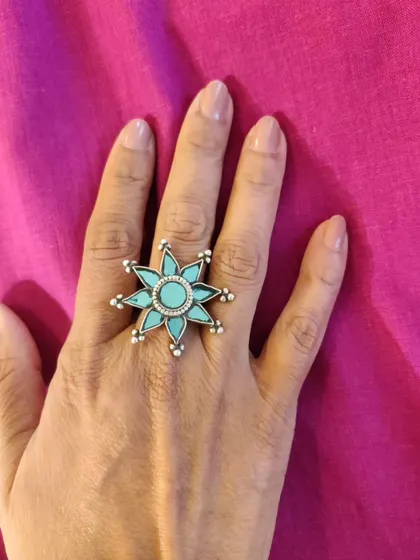 A close-up of the stunning turquoise statement ring. A single, bold piece of jewelry like this can be all you need to make an outfit memorable.