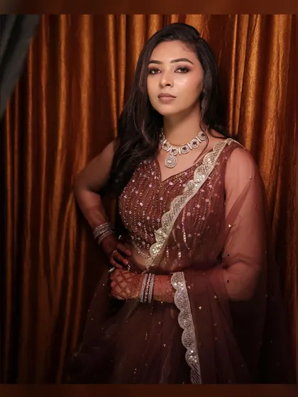 A stunning portrait of the bride in her glamorous reception lehenga, her pose confident and beautiful.