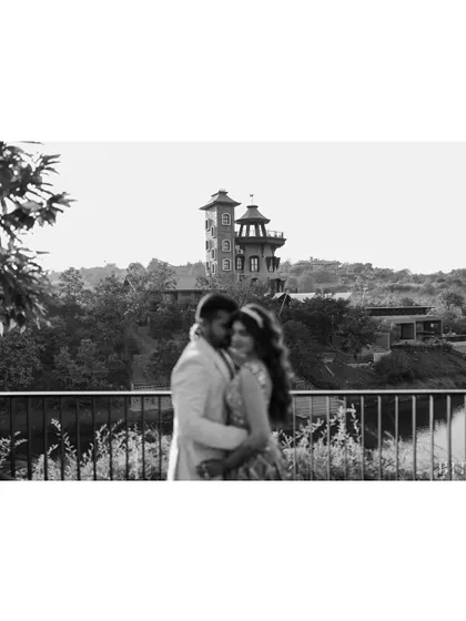A soft-focus, black and white shot of the couple embracing, with the venue in the background. This artistic choice creates a romantic, dreamlike atmosphere.