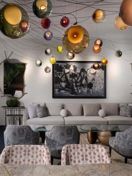 A view of the lounge seating under the magnificent Bocci light installation. The combination of our bespoke furniture, rich textiles, and dramatic lighting created an atmosphere of sophisticated warmth.